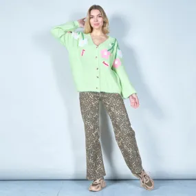 Pastel green cardigan with floral appliqués and butterfly embroidery