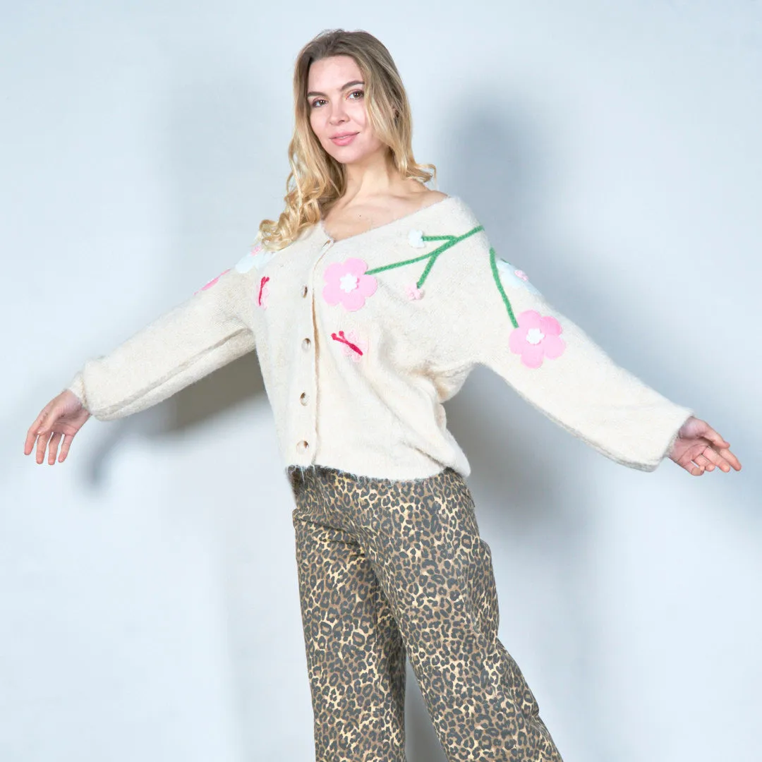 Pastel green cardigan with floral appliqués and butterfly embroidery